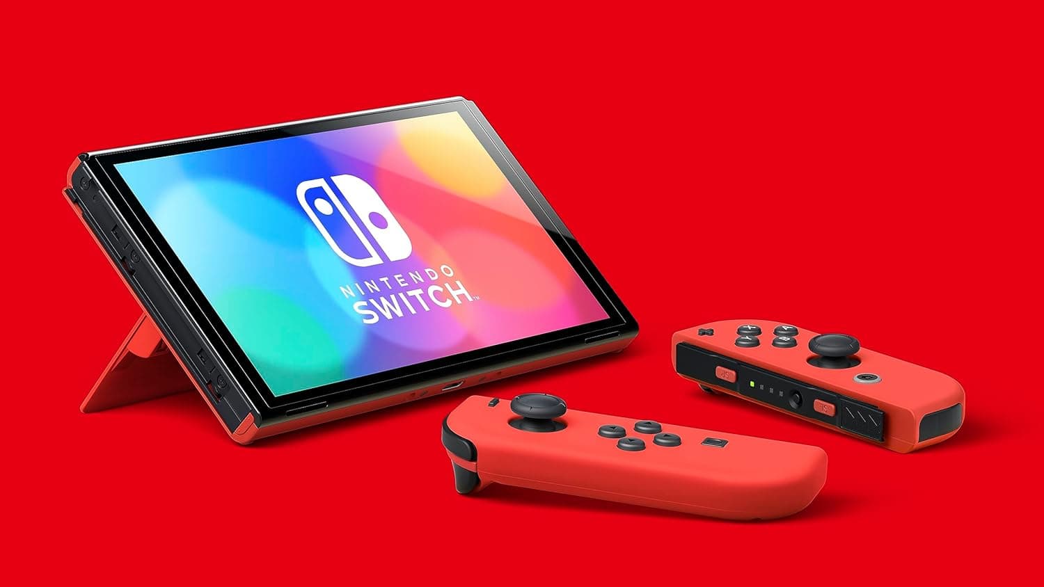 Nintendo Switch OLED Model in red, docked mode with Joy-Con controllers